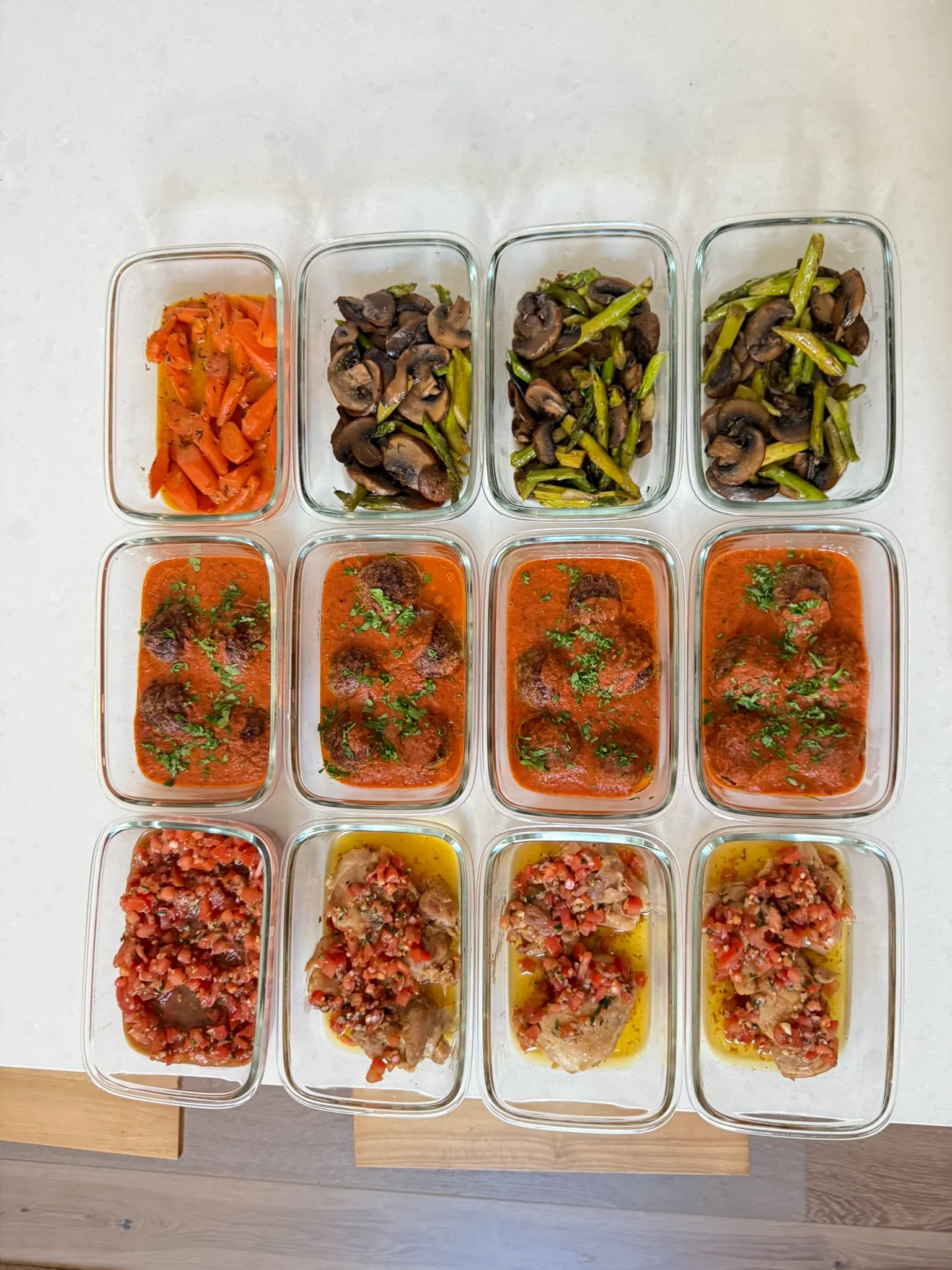 Weekly meal prep containers with meatballs, roasted veggies, and fresh salsa