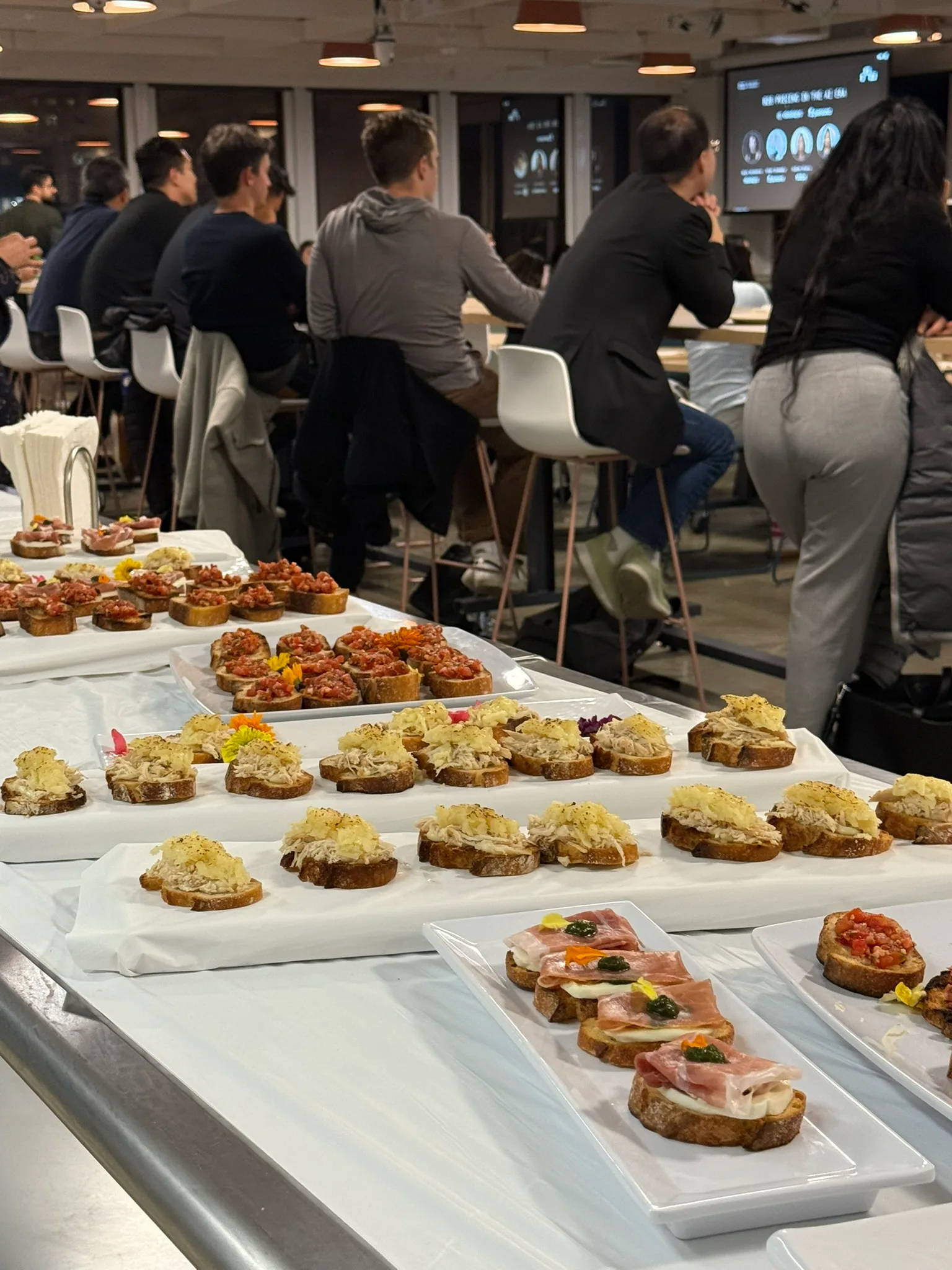 Catering table at a corporate event with assorted bruschetta and crostini